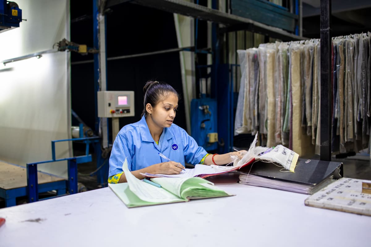 A quality technician reviewing inspection documentation